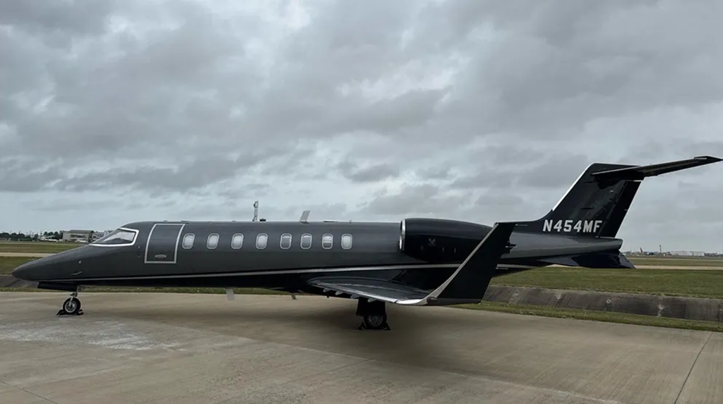 Starboard-side exterior view of black Learjet 45 N454MF