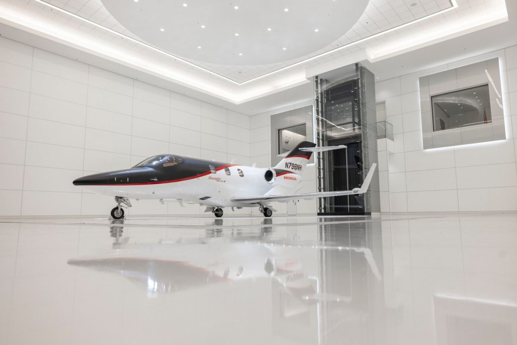 Wide exterior view of the 2025 HondaJet Elite II in a bright aircraft showroom